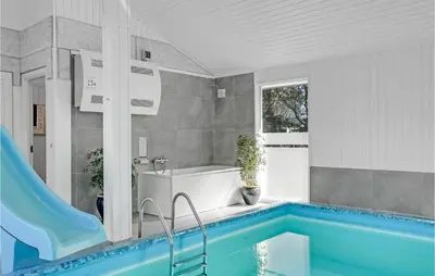 a bathroom with a tub and a swimming pool at Gorgeous Home In Blokhus With Sauna in Blokhus