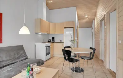 a kitchen and living room with a table and chairs at 2 Bedroom Beautiful Home In Pandrup in Pandrup