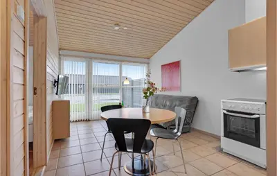 a kitchen with a table and chairs in a room at 2 Bedroom Beautiful Home In Pandrup in Pandrup