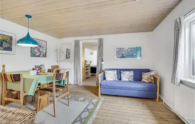 a living room with a blue couch and a table at Gorgeous Apartment In Blokhus With Wifi in Blokhus
