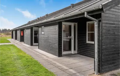 a black building with a large door on the side at 2 Bedroom Stunning Home In Pandrup in Pandrup