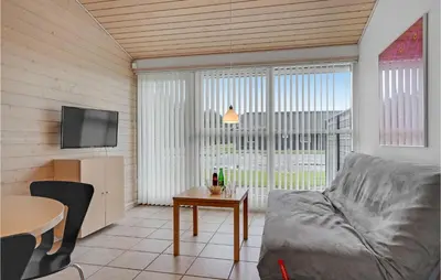 a living room with a couch and a table at 2 Bedroom Stunning Home In Pandrup in Pandrup