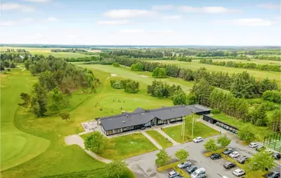 an aerial view of a building with a golf course at Cozy Home In Pandrup With Wifi in Pandrup