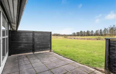 a gate on the side of a house with a field at Pet Friendly Home In Pandrup With Wifi in Pandrup