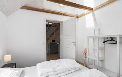 a bedroom with white walls and a bed with white sheets at 3 Bedroom Stunning Home In Pandrup in Pandrup