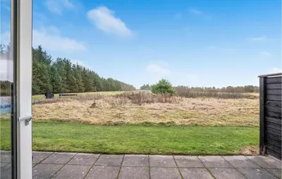 a view of a field through a sliding glass door at 2 Bedroom Nice Home In Pandrup in Pandrup