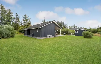 a black house with a large yard at Amazing Home In Brovst With Kitchen in Brovst