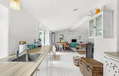a kitchen with a sink and a living room at Stunning Home In Thisted With Wifi in Thisted