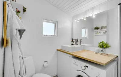 a bathroom with a sink and a washing machine at Stunning Home In Thisted With Wifi in Thisted