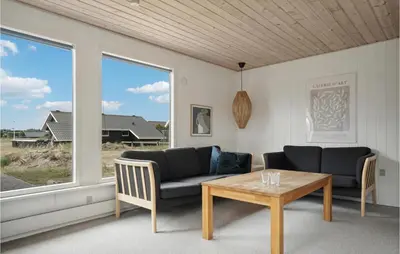 a living room with two couches and a table at Nice Home In Thisted With Kitchen in Thisted