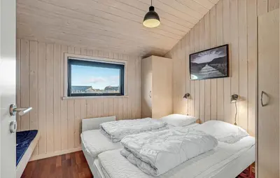 a bedroom with a bed in a room with a window at 3 Bedroom Awesome Home In Harboøre in Harboør