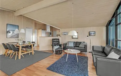 a living room with a couch and a table at 3 Bedroom Awesome Home In Harboøre in Harboør