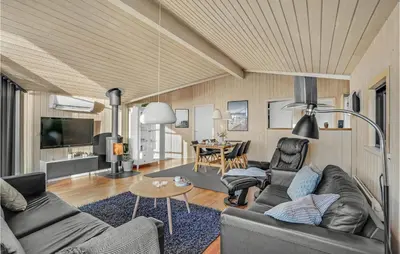 a living room with a couch and a table at 3 Bedroom Awesome Home In Harboøre in Harboør