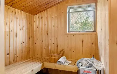 a wooden sauna with a window and a trash can at Beautiful Home In Thisted With Kitchen in Thisted