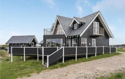 a house on the side of a beach at Lovely Home In Harboøre With Sauna in Harboør