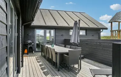 a patio with an umbrella and a table and chairs at Lovely Home In Thisted With Sauna in Thisted