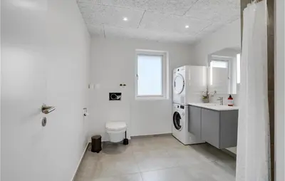 a white bathroom with a toilet and a sink at Lovely Home In Thisted With Sauna in Thisted