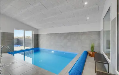 a swimming pool in a room with a large window at Lovely Home In Thisted With Sauna in Thisted