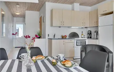 a kitchen with a table with plates of food on it at Amazing Home In Vestervig With Sauna in Vestervig