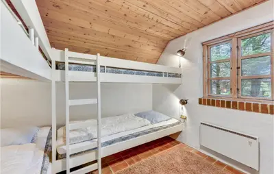 a bedroom with bunk beds in a tiny house at Cozy Home In Vestervig With Sauna in Vestervig