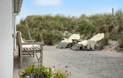 a group of chairs sitting on the beach at Gorgeous Home In Lemvig With Sauna in Lemvig