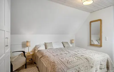a white bedroom with a bed and a mirror at Gorgeous Home In Lemvig With Sauna in Lemvig