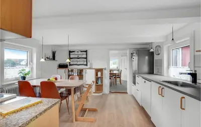 a kitchen and living room with a table and a dining room at Lovely Home In Thisted With Kitchen in Thisted