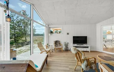 a living room with a large window and a tv at Cozy Home In Thisted With Sauna in Thisted