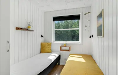 a small room with two beds and a window at Cozy Home In Thisted With Sauna in Thisted