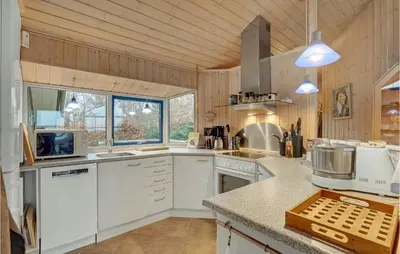 a kitchen with white cabinets and a counter top at Beautiful Home In Thyholm With Wifi in Thyholm