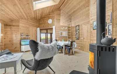 a room with a fireplace and a dining room at Gorgeous Home In Vinderup With Sauna in Vinderup