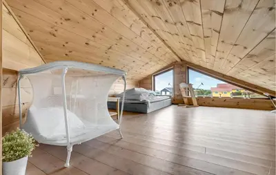 a bedroom with a bed in a wooden ceiling at Gorgeous Home In Vinderup With Sauna in Vinderup