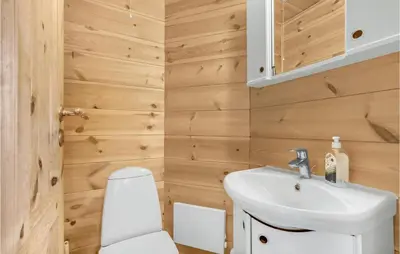 a bathroom with a white sink and a toilet at Gorgeous Home In Vinderup With Sauna in Vinderup