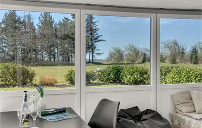 a room with three windows and a table and chairs at Stunning Home In Vemb With Wifi in Vemb