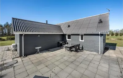a house with a patio with a table and a building at Stunning Home In Vemb With Wifi in Vemb