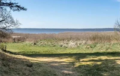 a dirt road leading to a field with a body of water at Stunning Home In Vemb With Wifi in Vemb