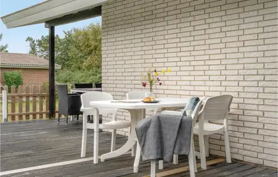 a white table and chairs on a deck at 3 Bedroom Amazing Home In Hurup Thy in Sindrup