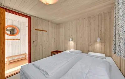 a bedroom with a white bed and a window at 3 Bedroom Gorgeous Home In Thyholm in Thyholm