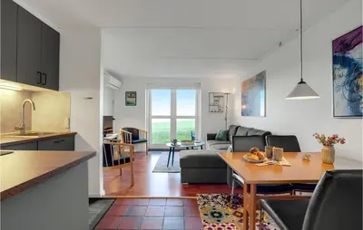 a kitchen and a living room with a table in a room at Gorgeous Apartment In Lemvig in Lemvig