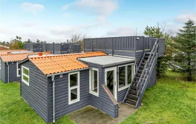 a tiny house with a staircase on the side of it at Cozy Home In Hanstholm With Wifi in Hanstholm