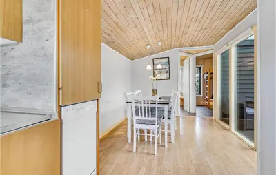 a kitchen and dining room with a table and chairs at Cozy Home In Hanstholm With Wifi in Hanstholm