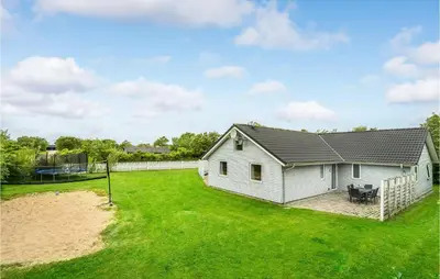a white house with a yard and a fence at 7 Bedroom Gorgeous Home In Vinderup in Vinderup