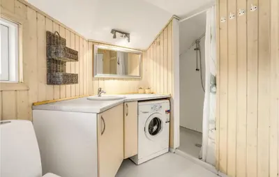 a bathroom with a washing machine and a sink at 4 Bedroom Lovely Home In Fjerritslev in Fjerritslev