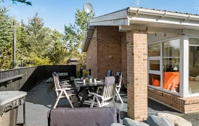 a patio with a table and chairs on a deck at Cozy Home In Fjerritslev With Wifi in Fjerritslev