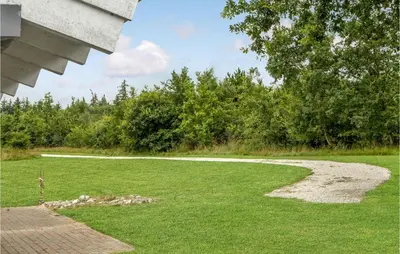 a grassy yard with a walkway in the distance at 3 Bedroom Beautiful Home In Frøstrup in Frøstrup