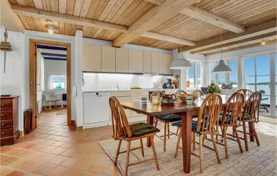 a kitchen and dining room with a table and chairs at Beautiful Home In Frøstrup With Sauna in Frøstrup