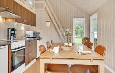 a kitchen with a wooden table and chairs in a room at Stunning Home In Hanstholm With Wifi in Hanstholm