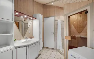 a white bathroom with a sink and a mirror at 3 Bedroom Cozy Home In Højslev in Højslev