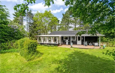a house with a porch and a yard at 2 Bedroom Awesome Home In Farsø in Farsø