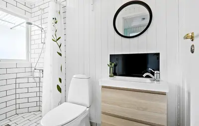 a bathroom with a toilet and a sink and a mirror at 2 Bedroom Awesome Home In Farsø in Farsø